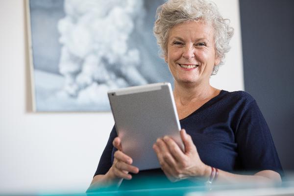 Eine Seniorin bedient ein Tablet