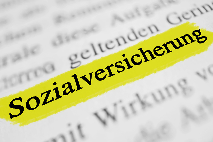 Auf einem Dokument ist das Wort Sozialversicherung gelb markiert. Auf einem Dokument ist das Wort Sozialversicherung gelb markiert.