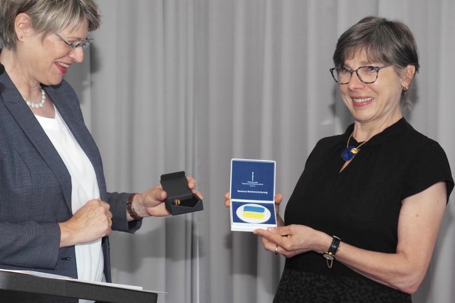 Gundula Roßbach, Präsidentin der Deutschen Rentenversicherung Bund, übergibt die Verdienstmedaille der Deutschen Rentenversicherung an Ingrid Künzler, ehemalige Geschäftsführerin und Erste Direktorin der Deutschen Rentenversicherung Nord. Gundula Roßbach, Präsidentin der Deutschen Rentenversicherung Bund, übergibt die Verdienstmedaille der Deutschen Rentenversicherung an Ingrid Künzler, ehemalige Geschäftsführerin und Erste Direktorin der Deutschen Rentenversicherung Nord.