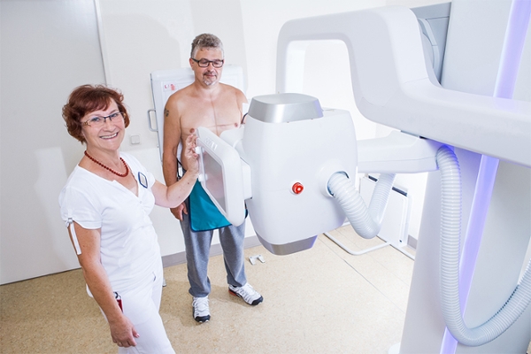 Ein Patient und eine Pflegerin bei einer Röntgenuntersuchung. Ein Patient und eine Pflegerin bei einer Röntgenuntersuchung.