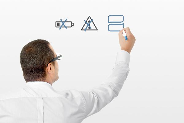 Ein Mann zeichnet Symbole an eine Tafel Ein Mann zeichnet Symbole an eine Tafel